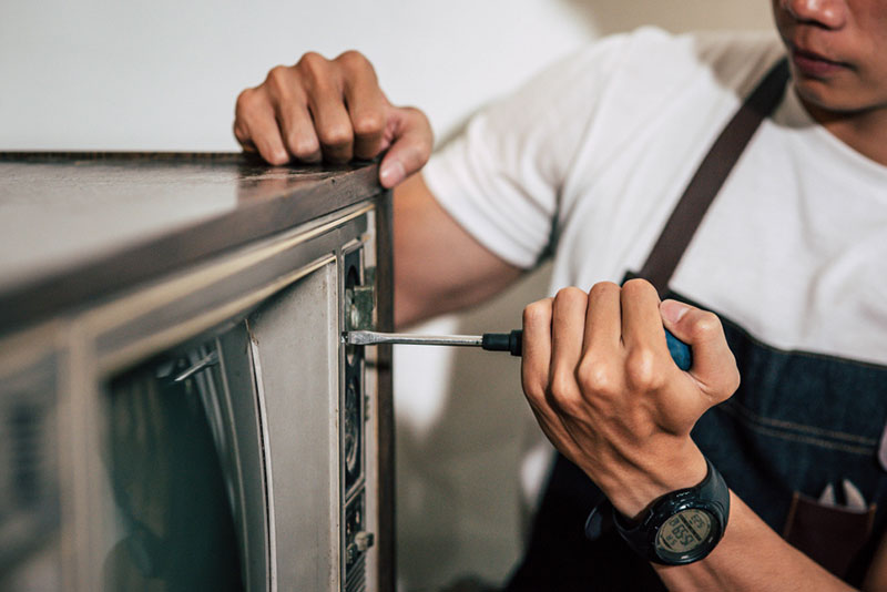Technician repairing appliance
